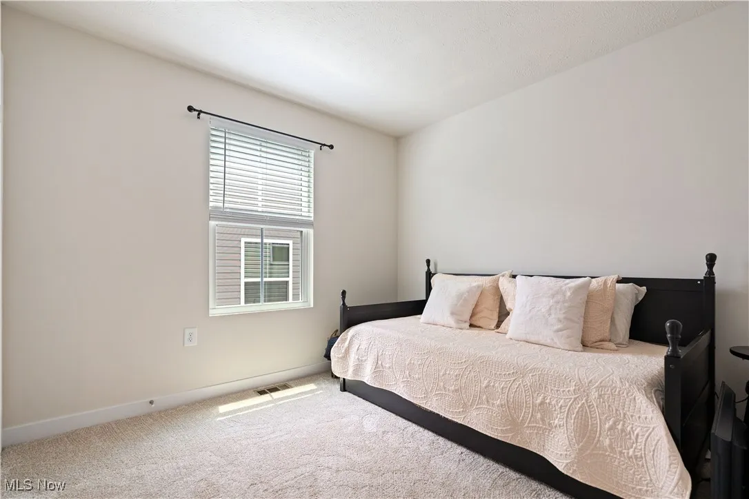 Carpeted bedroom featuring baseboards