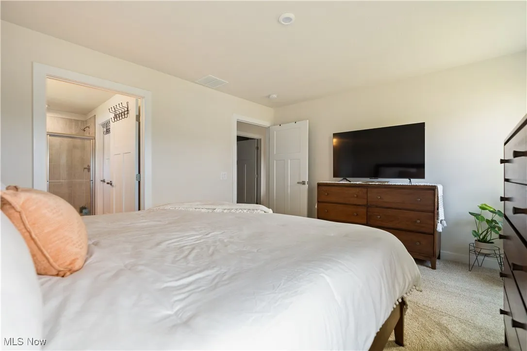 Carpeted bedroom featuring baseboards
