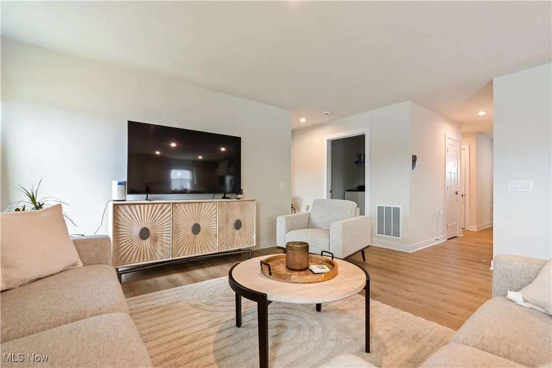 Living area featuring wood finished floors and recessed lighting