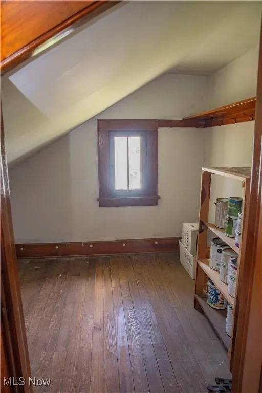 Additional living space featuring lofted ceiling and hardwood / wood-style floors