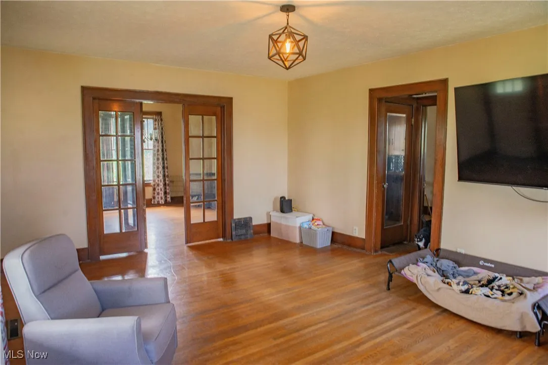 Sitting room with french doors and wood finished floors