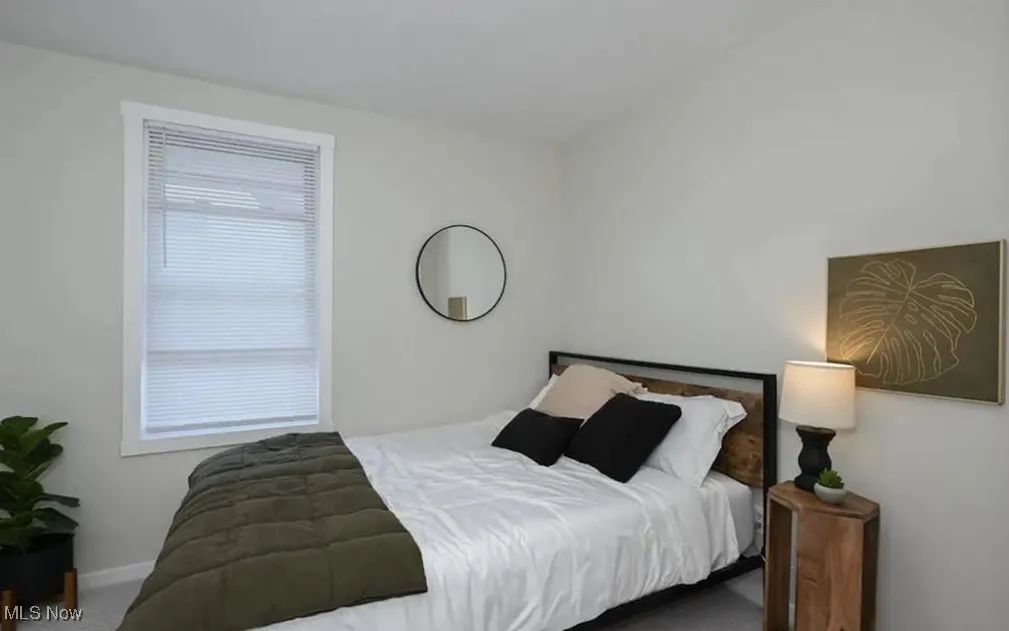 Carpeted bedroom featuring baseboards