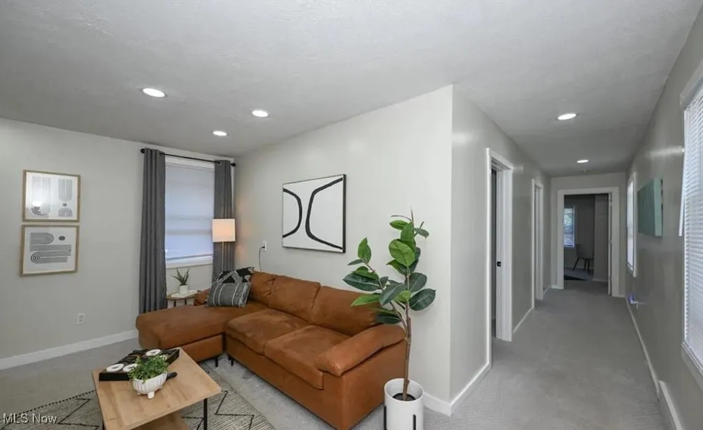 Carpeted living room featuring recessed lighting