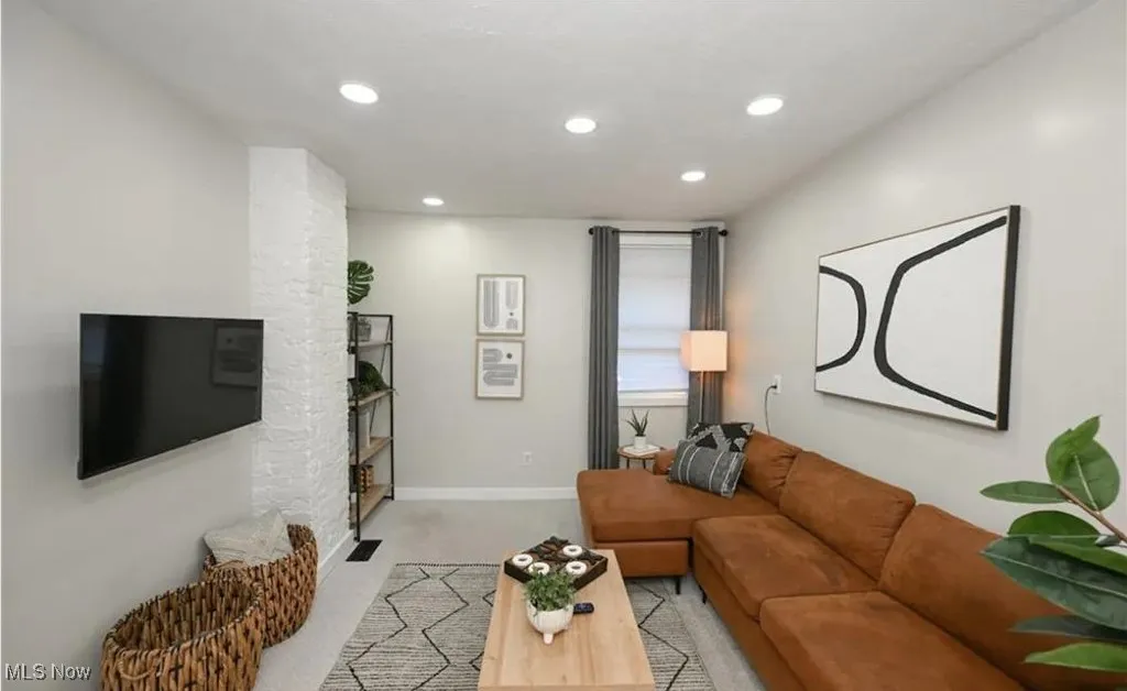Living room with recessed lighting and light colored carpet