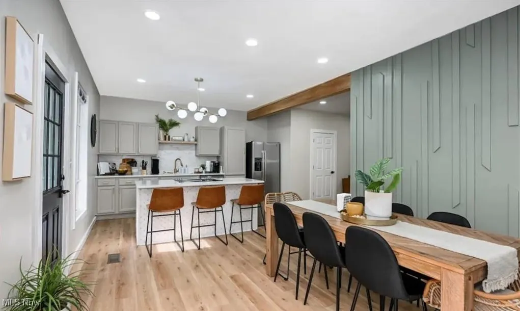 Dining area featuring light wood finished floors and recessed lighting