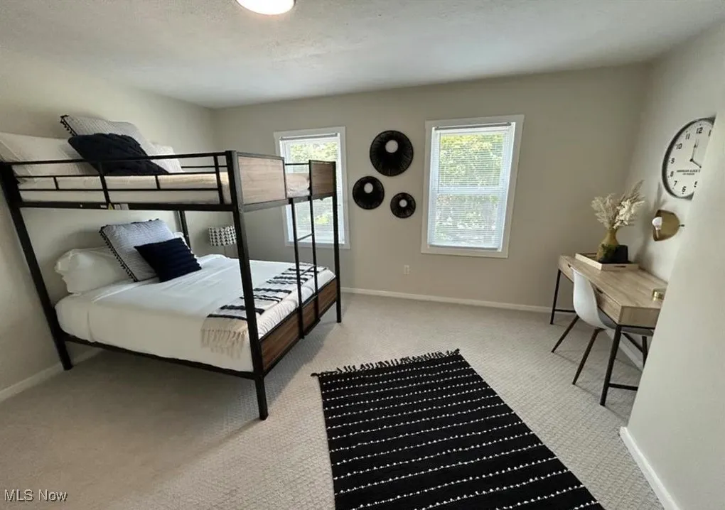 Carpeted bedroom with baseboards
