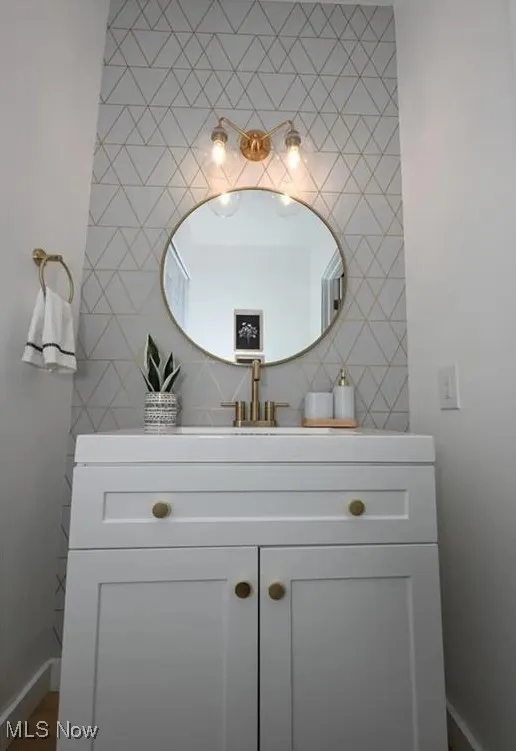 Bathroom with vanity and tile walls