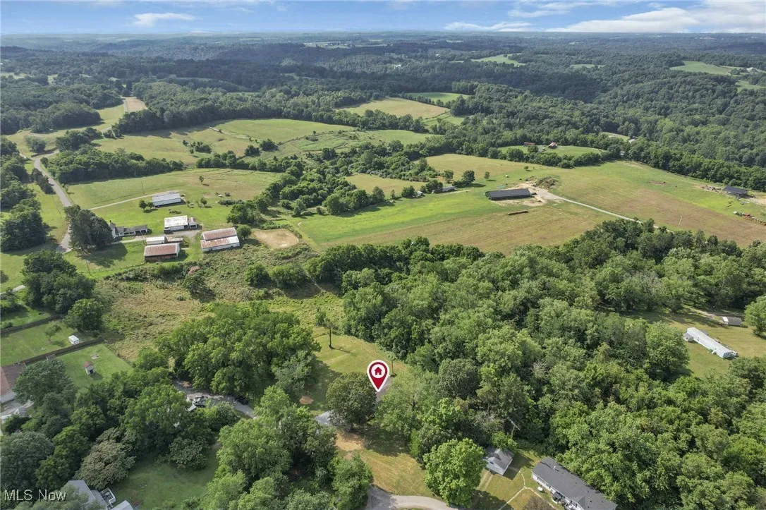Aerial overview of property's location featuring a heavily wooded area