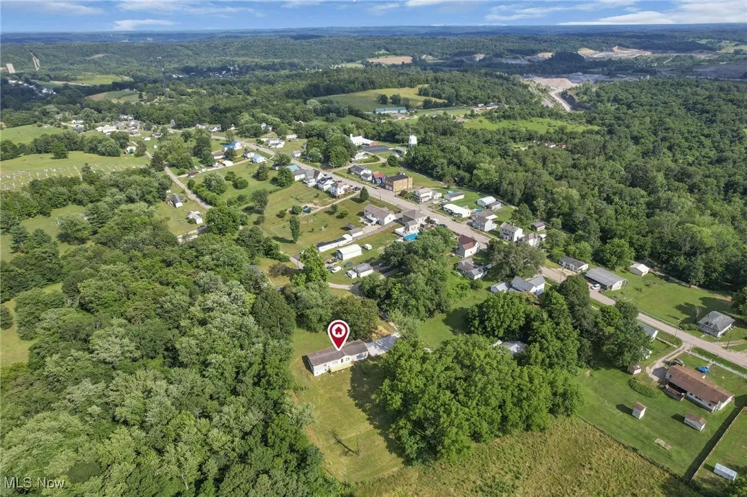 Aerial view of property's location with a forest