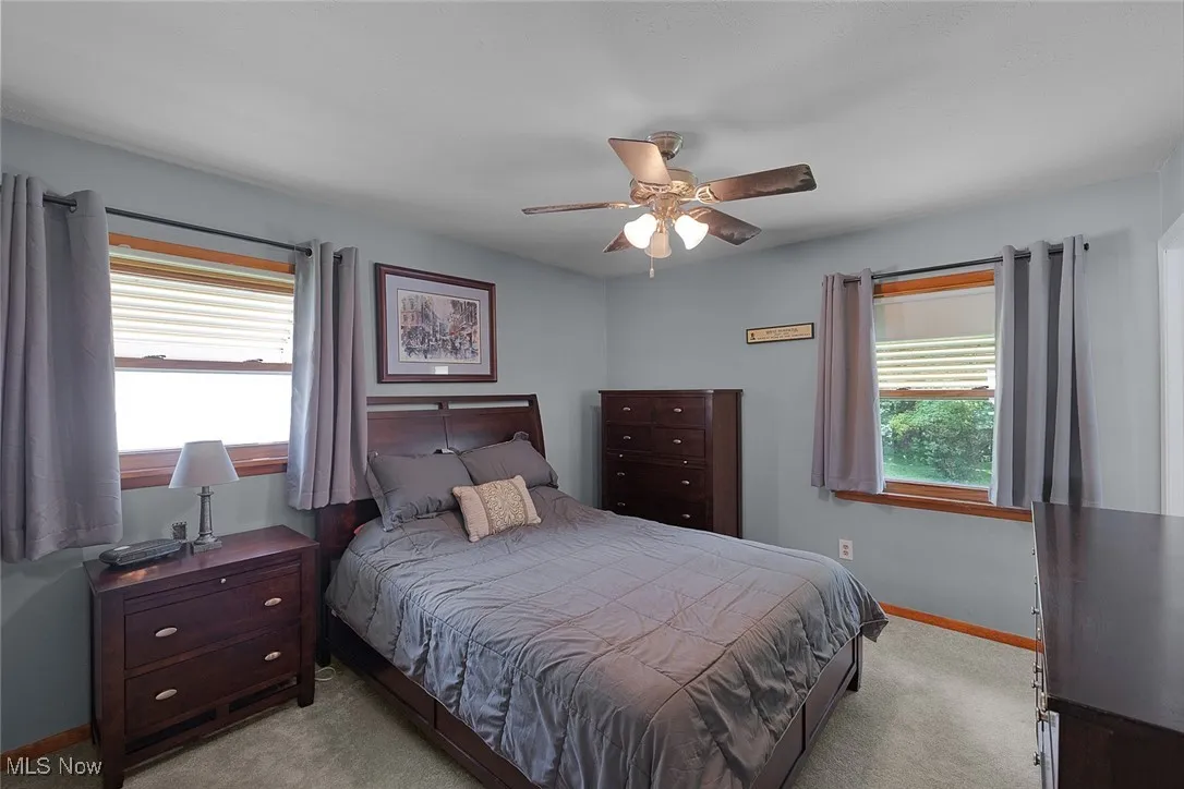 Bedroom with light carpet and ceiling fan