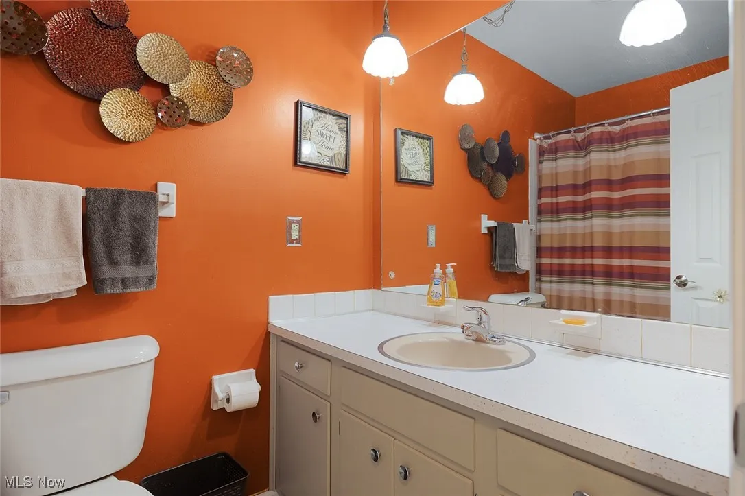 Bathroom featuring vanity and curtained shower