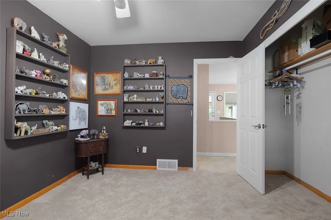 Office space with carpet floors and ceiling fan