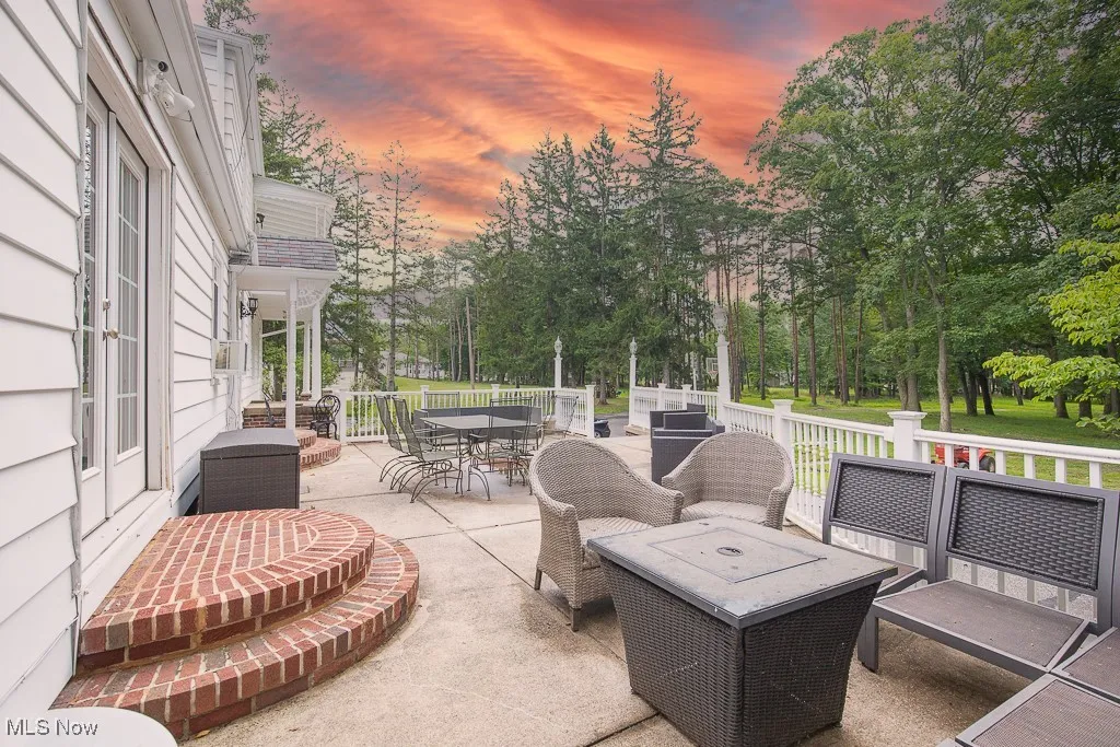View of patio with outdoor dining space and view of scattered trees