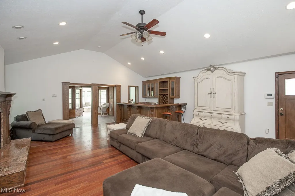 Living room featuring ceiling fan, wood finished floors, recessed lighting, and high vaulted ceiling