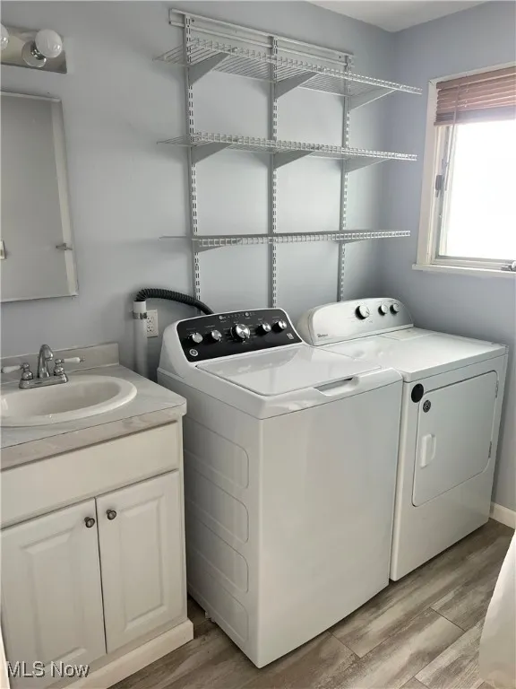 Main floor laundry/bathroom, light wood-style floors, and a sink