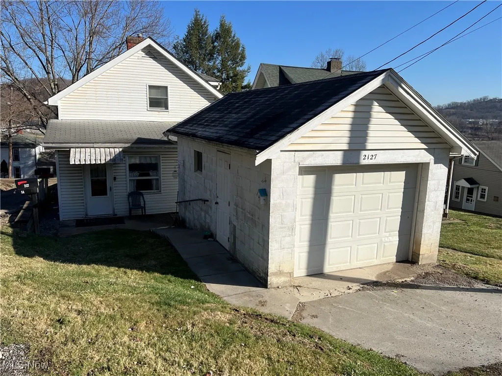 View of detached garage and back of the house