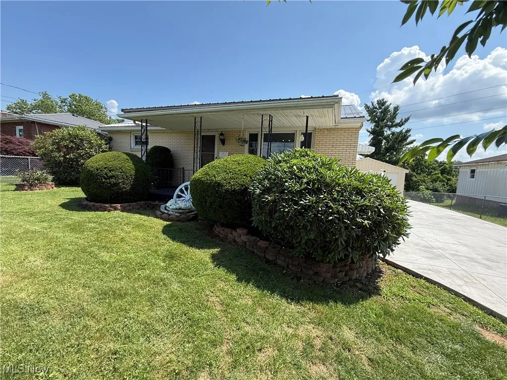 View of front of property with brick siding, driveway, and a garage