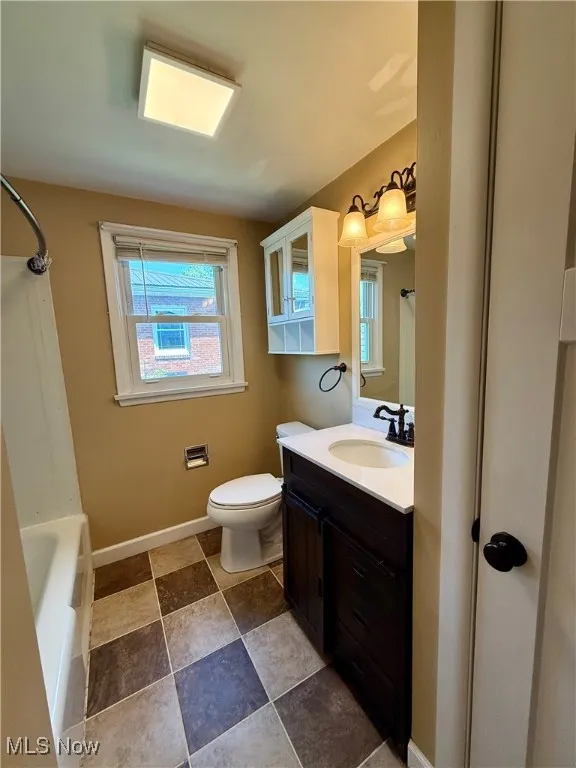Bathroom featuring vanity and shower / tub combo with curtain