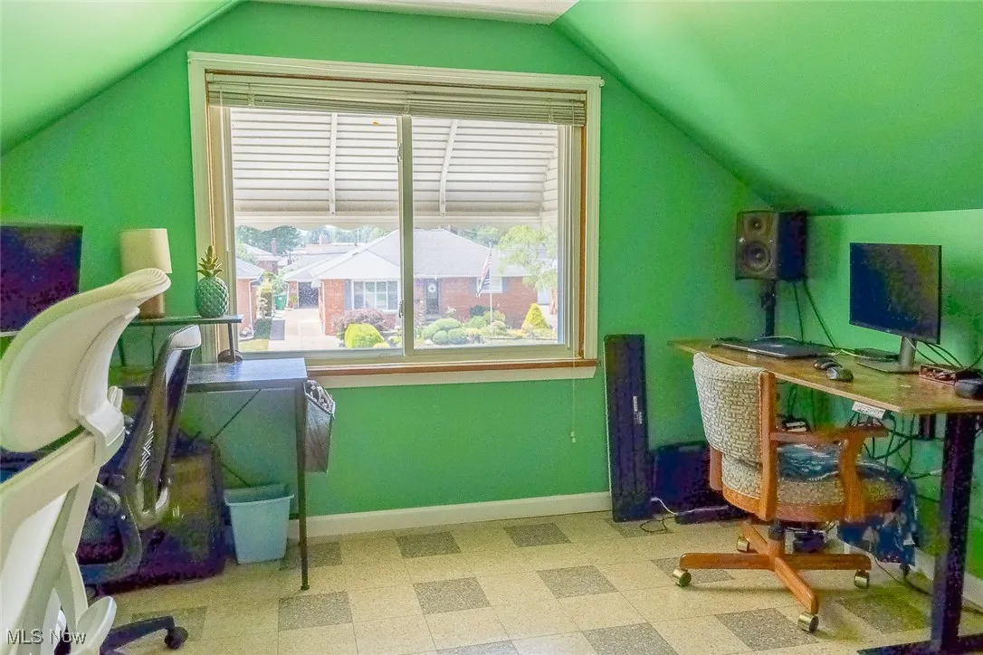 Office/Bedroom four area with lofted ceiling, plenty of natural light, and tile patterned floors