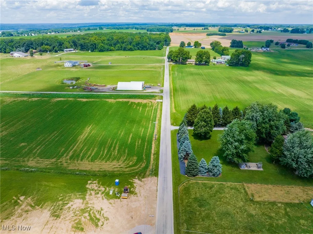 Aerial view of sparsely populated area with rows of crops