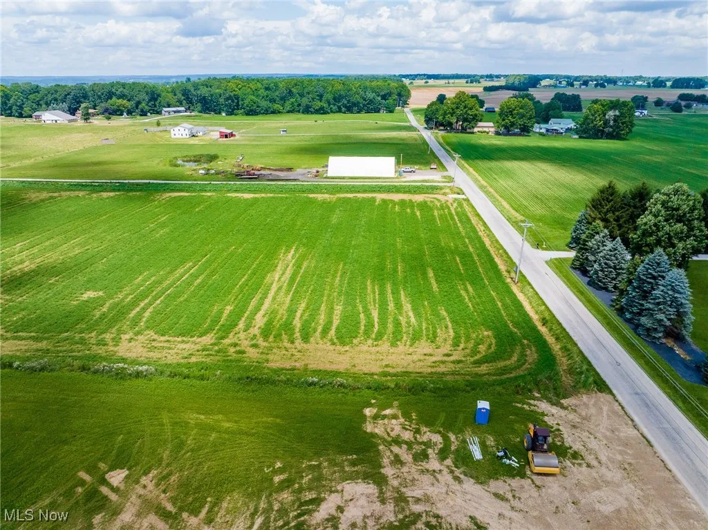 Aerial view of sparsely populated area with rows of crops