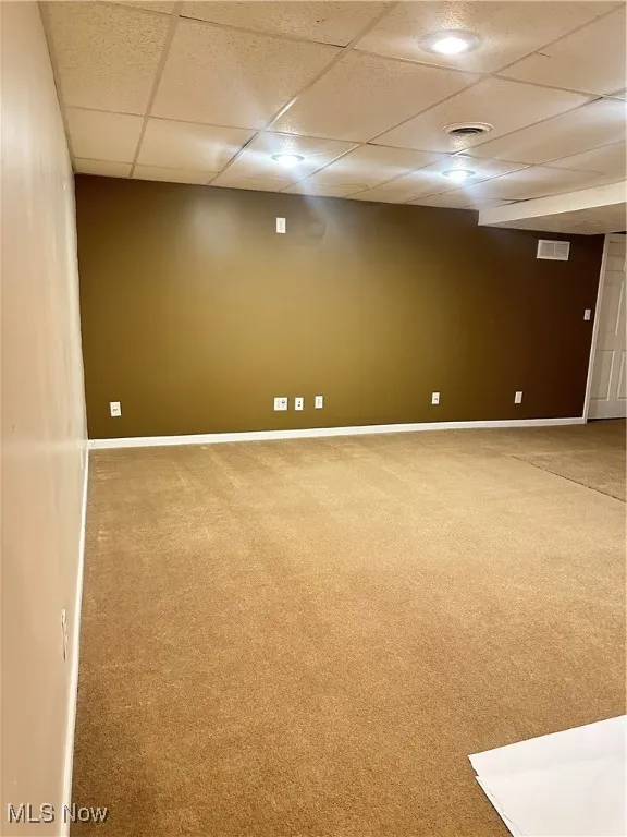 Finished below grade area with carpet and a drop ceiling
