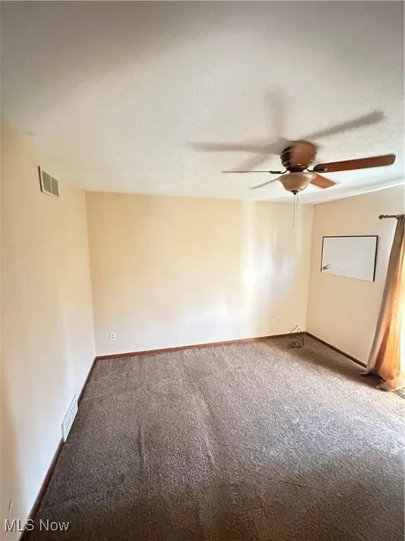 Carpeted bedroom with ceiling fan