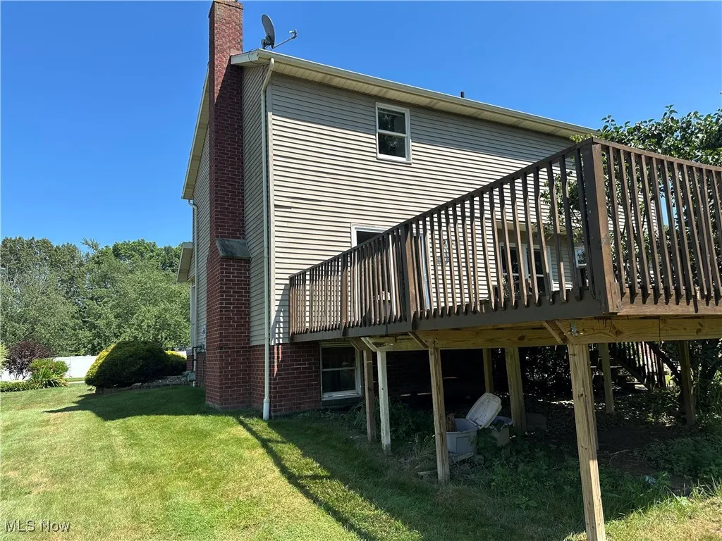 Back of house with a deck
