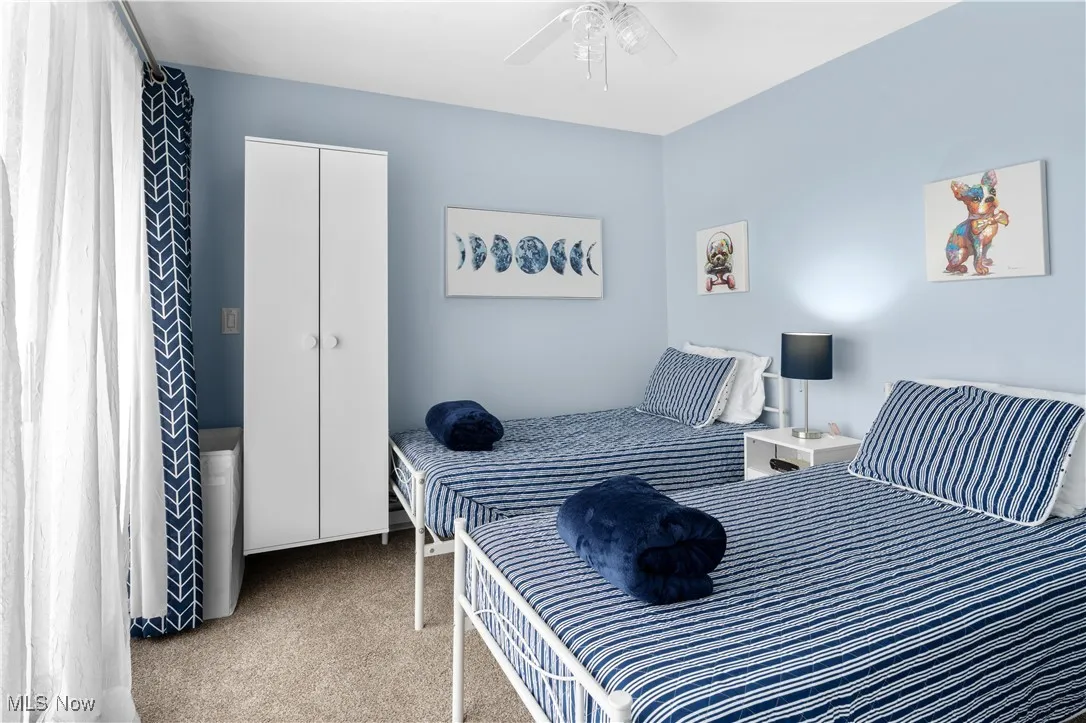 Bedroom featuring carpet flooring, a ceiling fan, and a closet