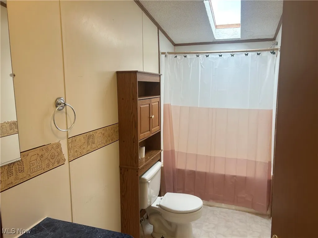 Full bathroom featuring ornamental molding and tile patterned floors