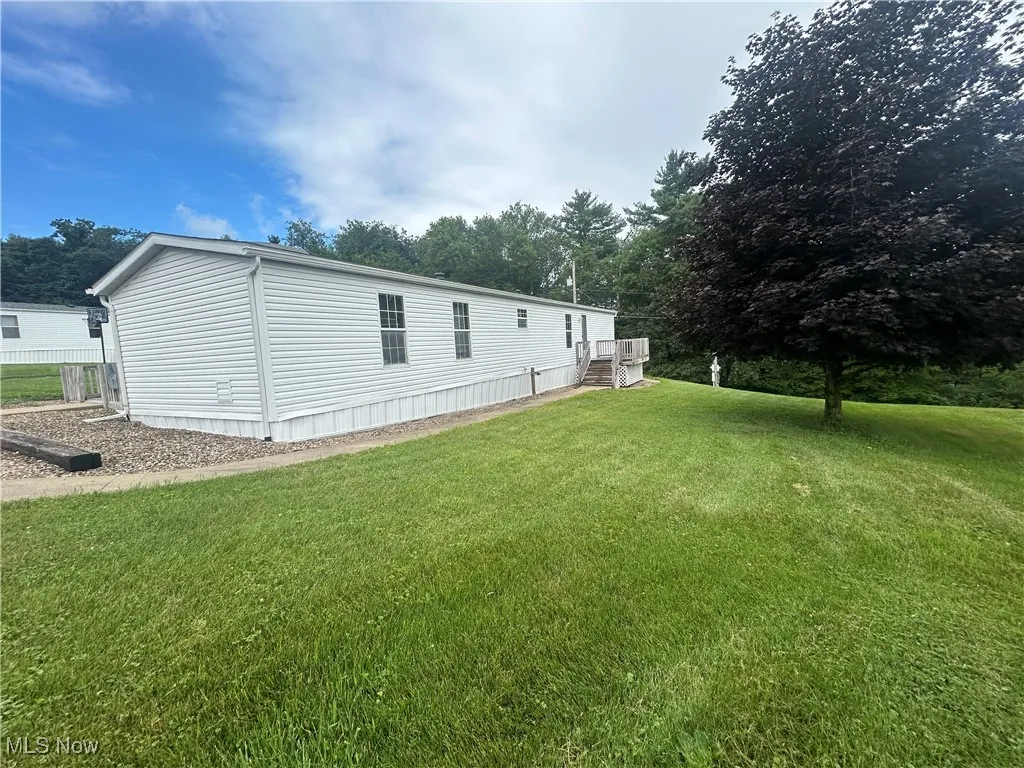 Rear view of property featuring a lawn