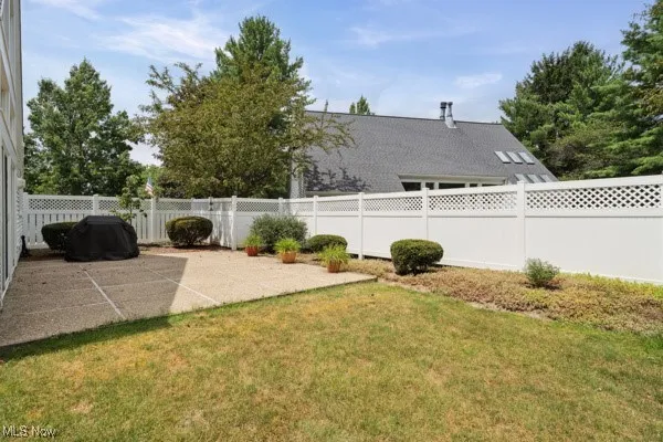 Fenced backyard featuring a patio