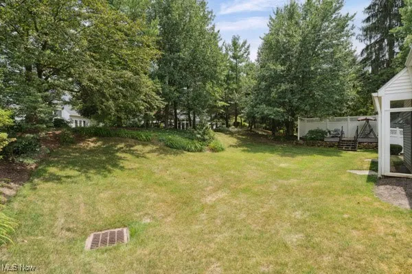 View of green lawn with a wooden deck