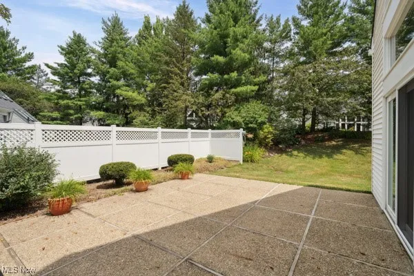 View of patio featuring view of wooded area
