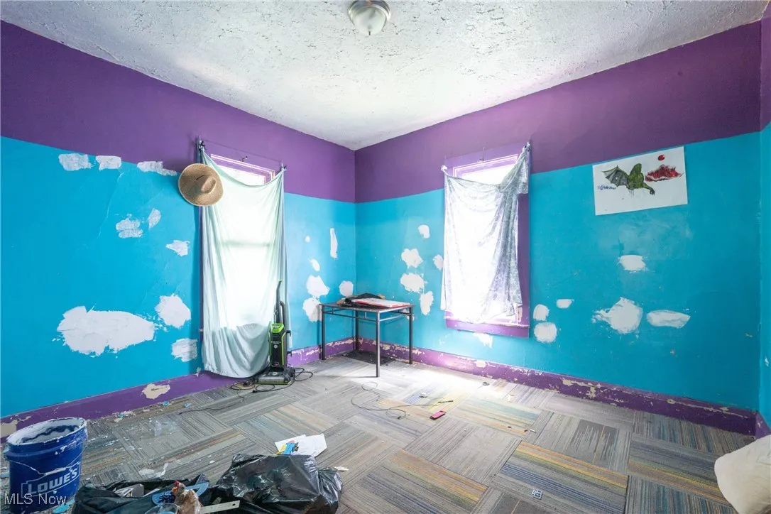 Bedroom featuring a textured ceiling and carpet