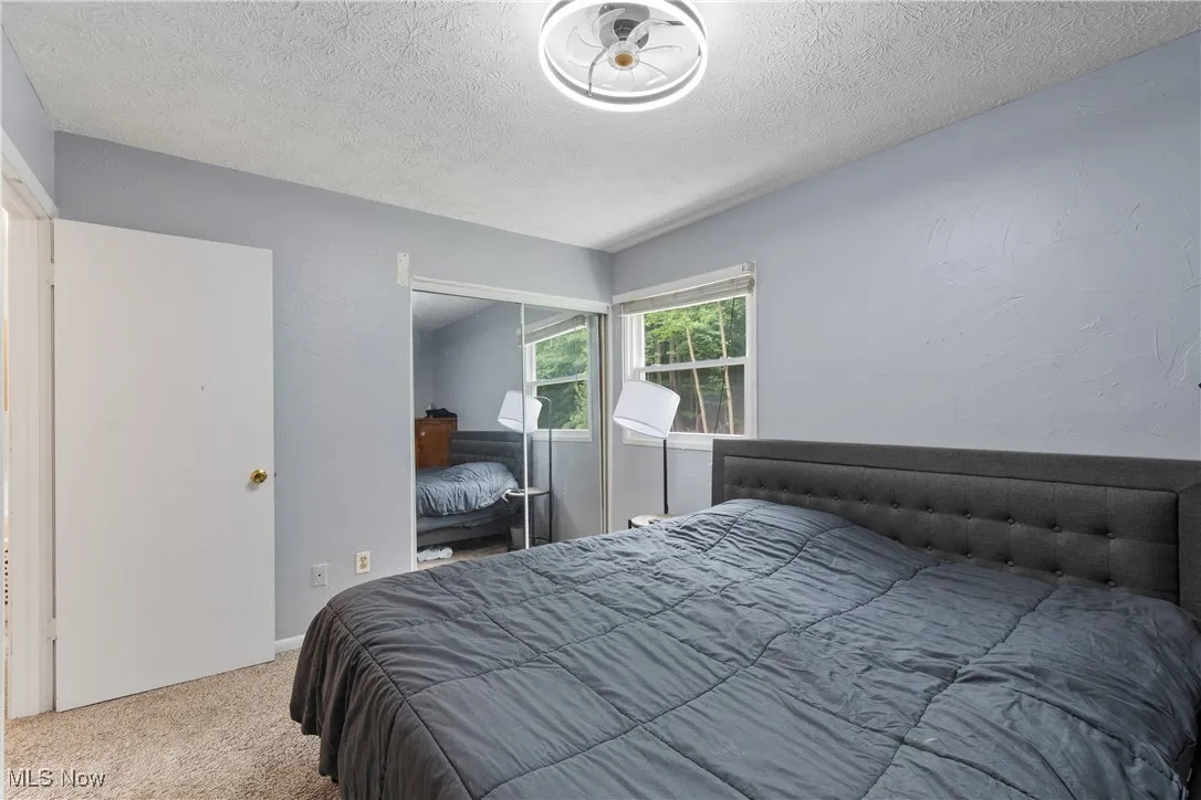Bedroom featuring carpet and a textured ceiling