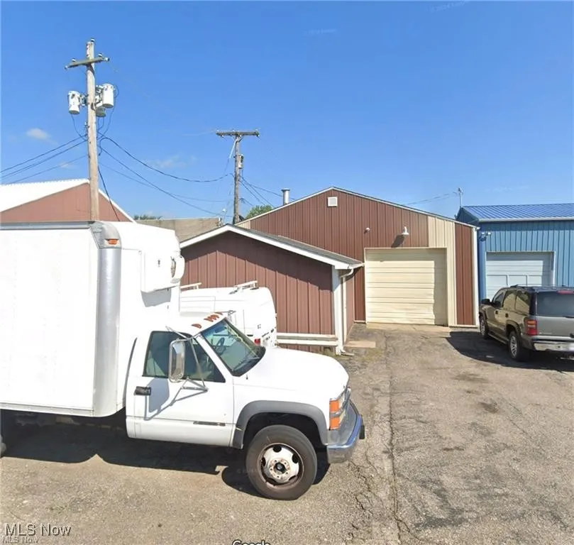 View of front of home with an outdoor structure and a garage