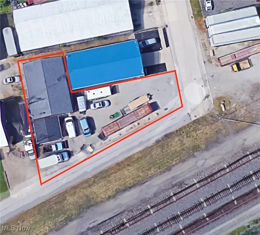 Aerial view of property and surrounding area featuring property parcel outlined