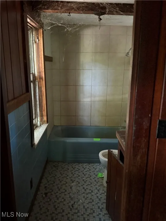 Bathroom with vanity, tile patterned floors, and  shower combination