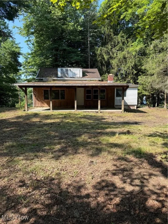Back of property with a chimney