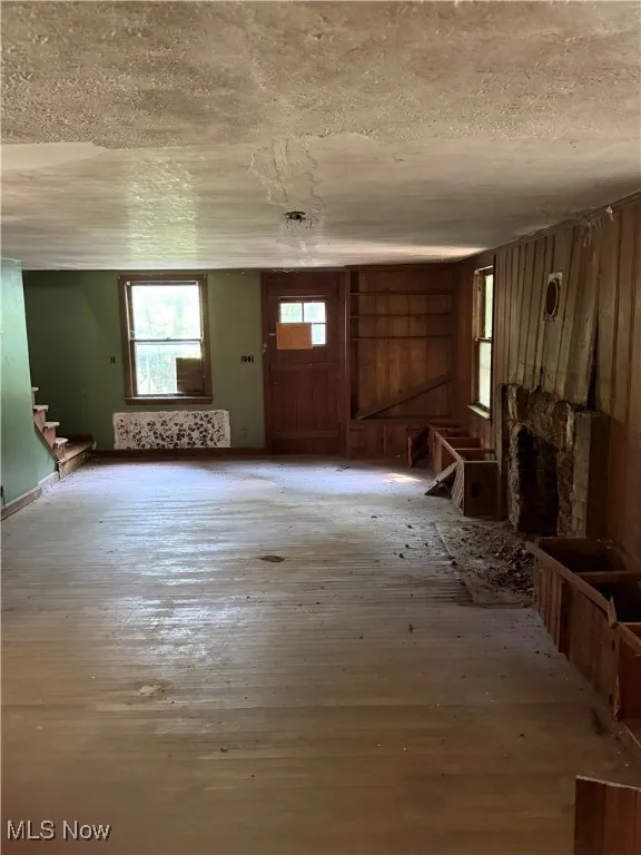 Entrance foyer featuring stairway, a textured ceiling, and light wood-style floors