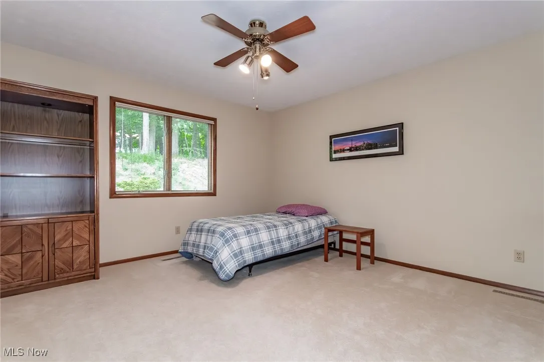 Bedroom with carpet and ceiling fan