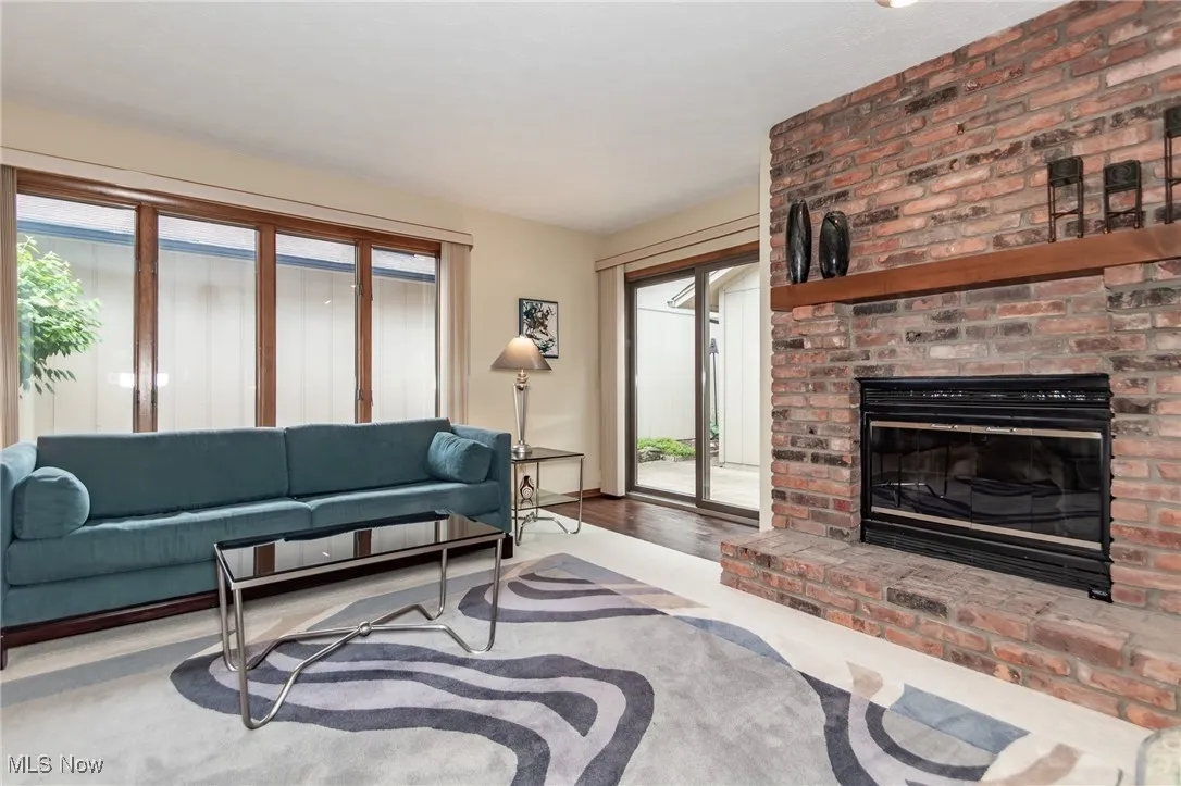 Living room with healthy amount of natural light and a fireplace