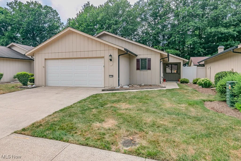 Ranch-style house with a garage and driveway