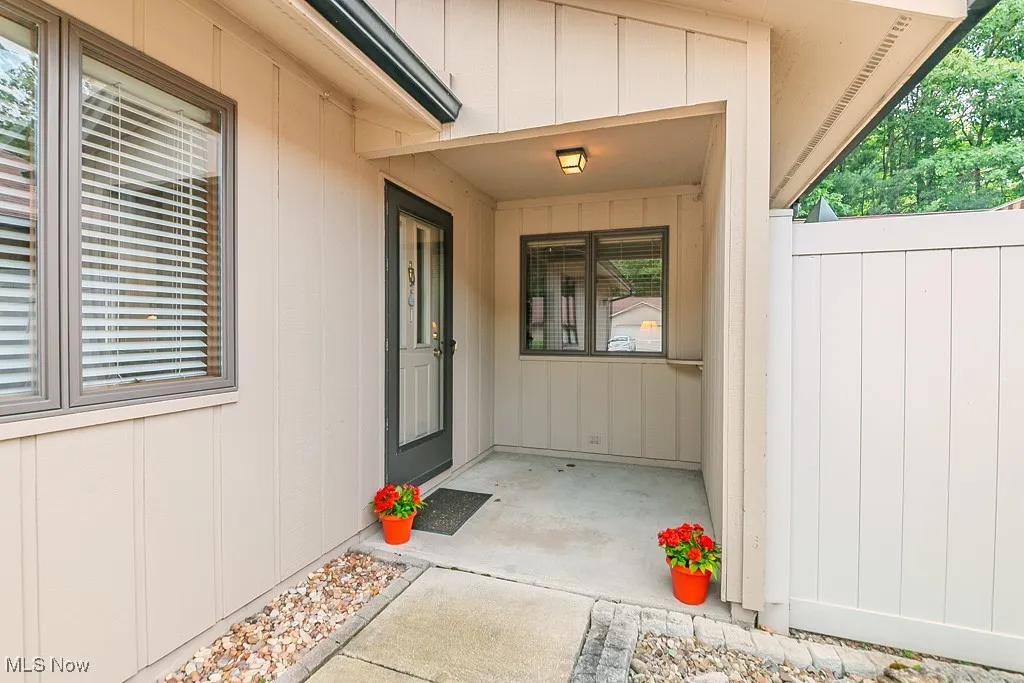 View of exterior entry featuring board and batten siding