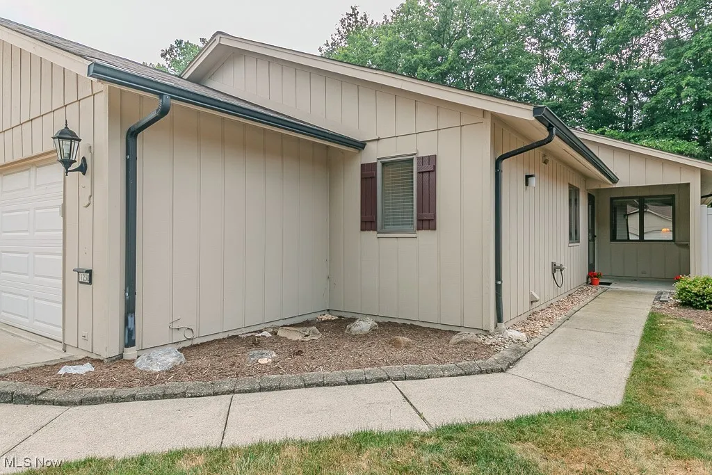 View of side of property featuring an attached garage