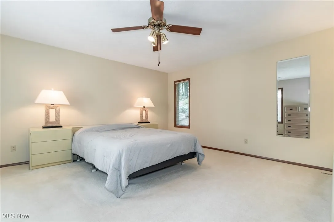 Bedroom featuring light carpet and a ceiling fan