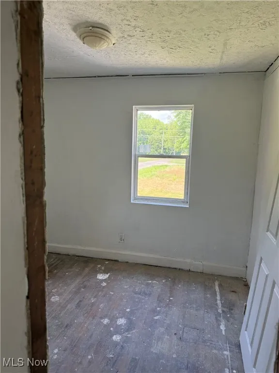 Unfurnished room with baseboards