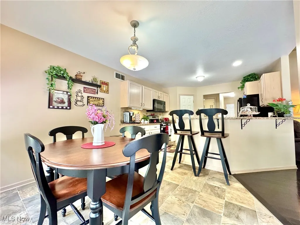 breakfast area featuring plenty of natural lighting and light flooring