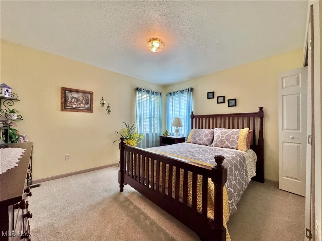 Bedroom with carpet and a textured ceiling